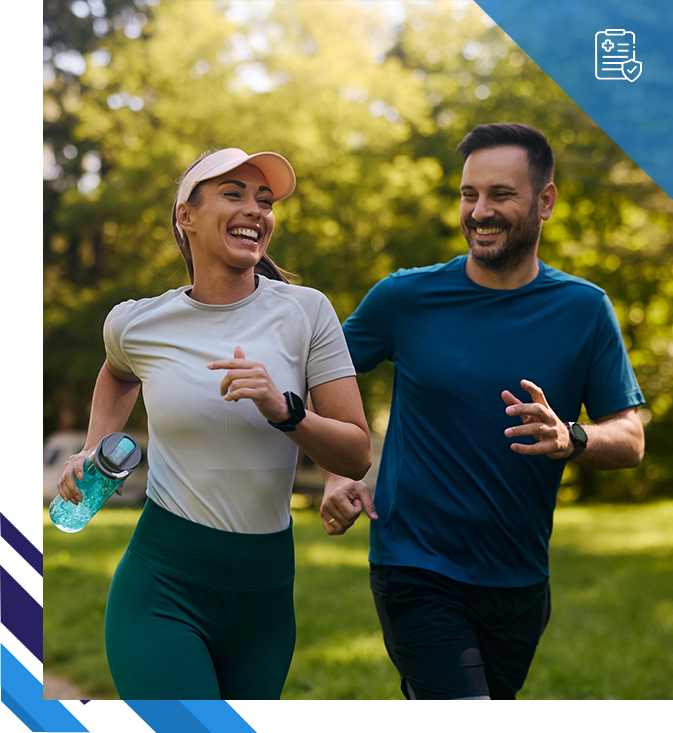 Happy couple running in a park.