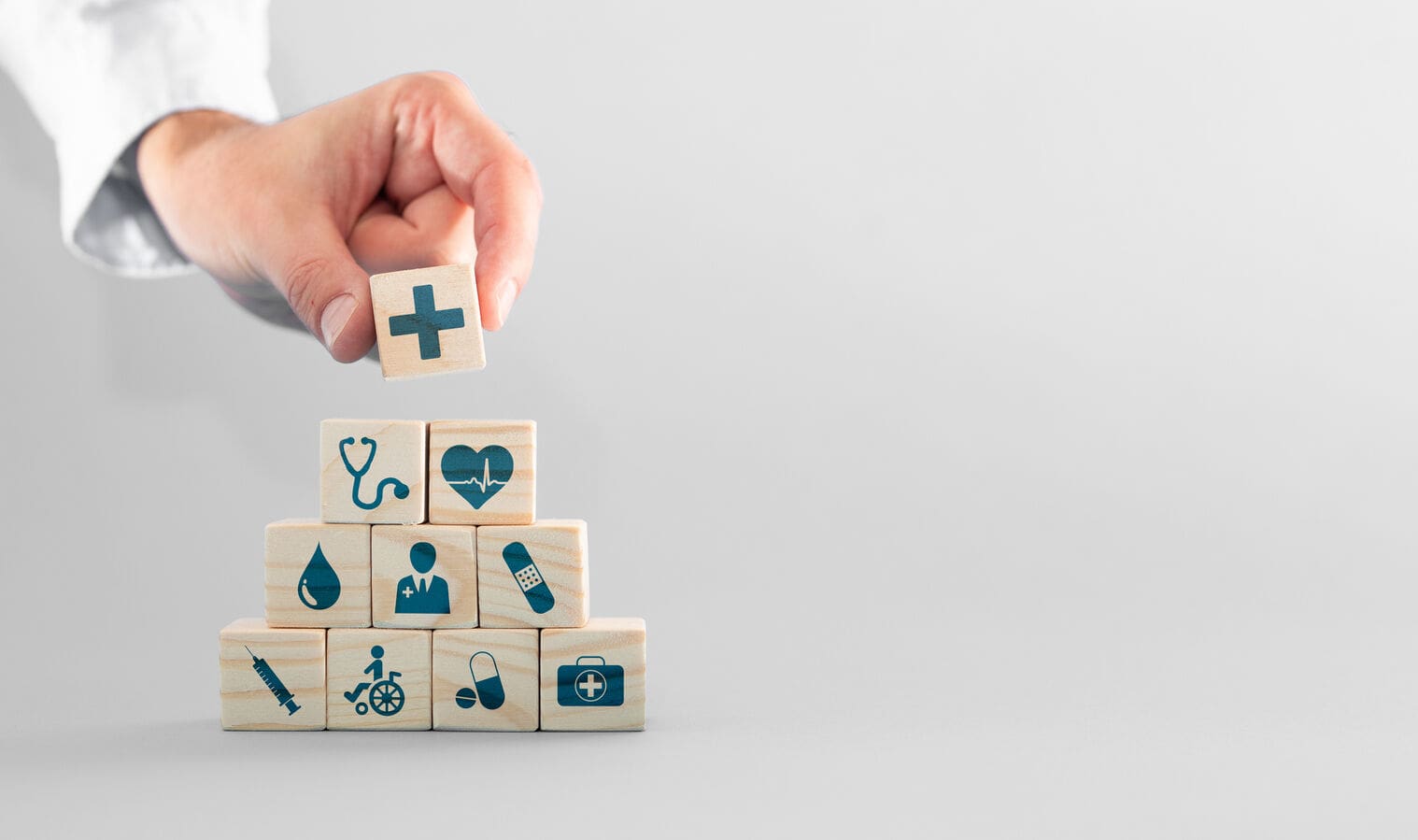 Wooden blocks with healthcare symbols.